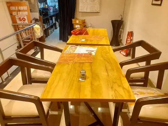 Cheese Corner interior with wooden tables